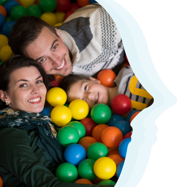 child and parents in ball pit
