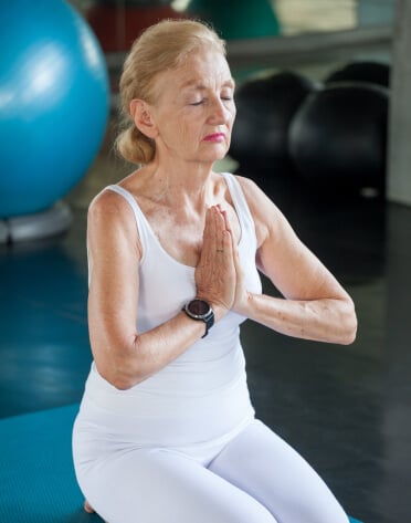 older woman doing yoga