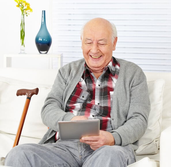 older man looking at tablet